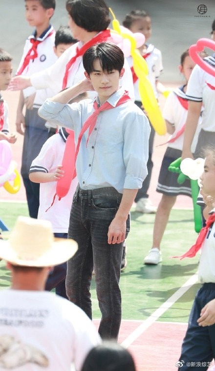 易烊千玺活动路透清爽帅气，蓝色衬衣戴红领巾化身校园学长